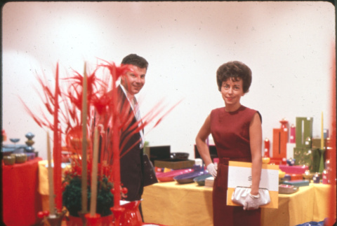 Man and woman standing by table display (ddr-densho-426-368)