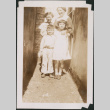 Woman, two girls and a boy in the narrow passageway (ddr-densho-483-585)