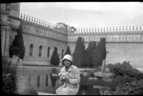 Tomoye (Nozawa) Takahashi, seated holding small dog (ddr-densho-426-1377)