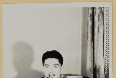 Man in armchair smoking a pipe (ddr-densho-287-728)