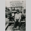 A man sitting on one of the many trucks used by the Pacific Beer Distributors (ddr-densho-353-148)