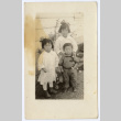 Three children outside a building (ddr-densho-433-573)