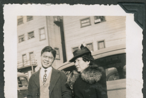 Photo of a man and woman beside a car (ddr-densho-483-361)