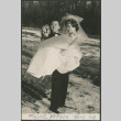 Black and white photo of groom carrying bride (ddr-densho-523-384)