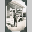 Man standing at attention outside building (ddr-ajah-2-115)