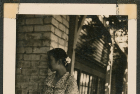 Woman leaning against a building (ddr-densho-433-820)