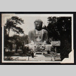 Three figures stand next to the Great Buddha of Kamakura (ddr-densho-404-150)