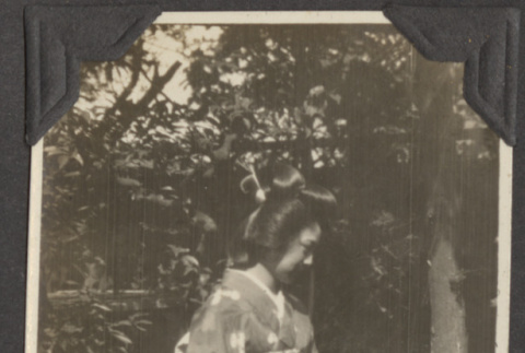 Nobuko Haguri standing in a garden (ddr-densho-432-41)