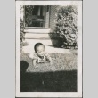 A baby playing in a yard (ddr-densho-316-61)