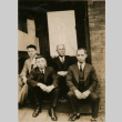 Four men sitting on building steps (ddr-densho-348-52)