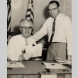 Two government workers posing behind a desk (ddr-njpa-2-336)