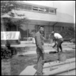 Two men working outside house (ddr-densho-377-1531)