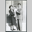 Photograph of Jean and Togo Tanaka with daughter Iye posing in front of a door in Cow Creek Camp in Death Valley (ddr-csujad-47-129)