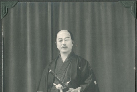 Man with wig and two katana in traditional costume (ddr-densho-321-53)