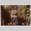 Man standing by ivy wall (ddr-densho-329-1202)