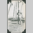 Man standing by palm trees (ddr-ajah-2-655)