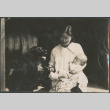 Woman holding baby, with dog (ddr-densho-523-61)