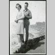 Photograph of Cleo and Pete Merritt standing on a short wall at Zabriskie Point in Death Valley (ddr-csujad-47-144)