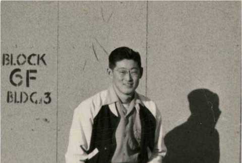 Japanese American in front of barracks (ddr-densho-159-301)