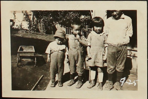 Four Nisei children in yard (ddr-densho-259-441)