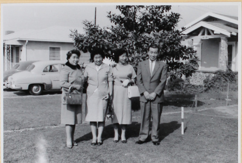 Three women and a man outside house (ddr-densho-522-60)