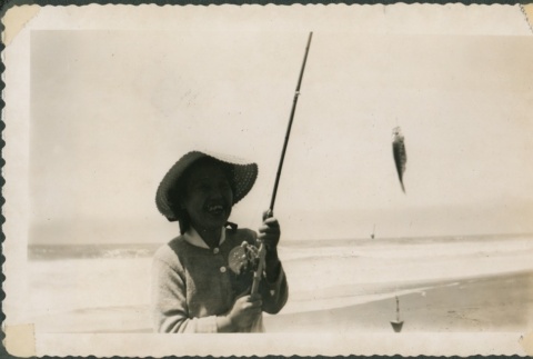 A woman with her catch during a fishing trip (ddr-densho-321-1127)