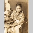 A sculptor posing in her workshop (ddr-njpa-4-1905)