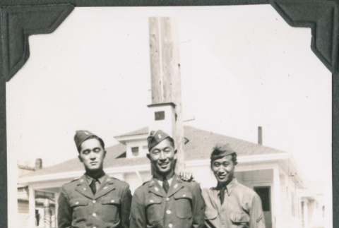 Three men standing in front of building.  Joe Iwataki in center (ddr-ajah-2-128)