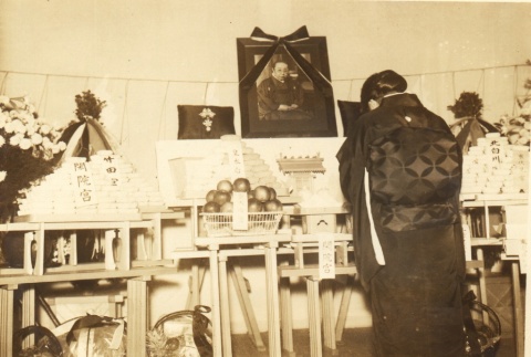 Woman bowing at a funeral altar (ddr-njpa-4-2157)