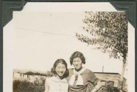 Woman and girl standing next to bench (ddr-densho-316-110)