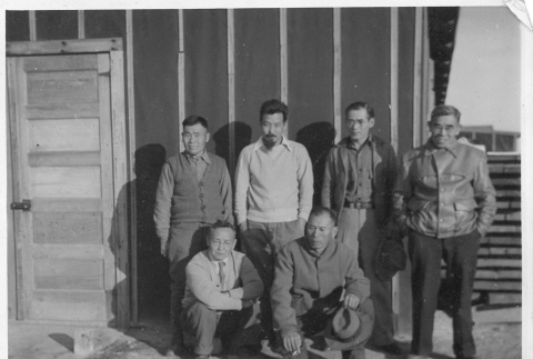 Japanese American men in front of barracks (ddr-densho-157-74)