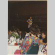 Woman on stage before a dinner crowd (ddr-densho-466-489)