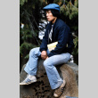 Paul Kawakami sitting on a stump (ddr-densho-336-349)