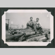 Two men sitting on a log pile (ddr-densho-471-90)