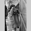 Camper taking a photograph with a Kodak Instamatic (ddr-densho-336-240)