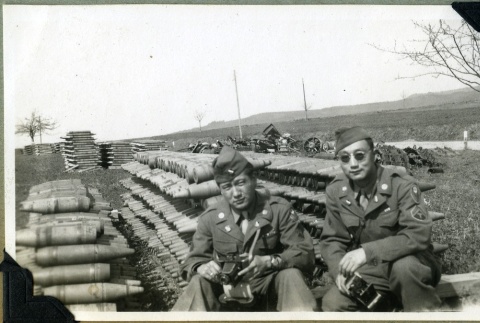 Soldiers near a stockpile of munitions (ddr-densho-22-84)