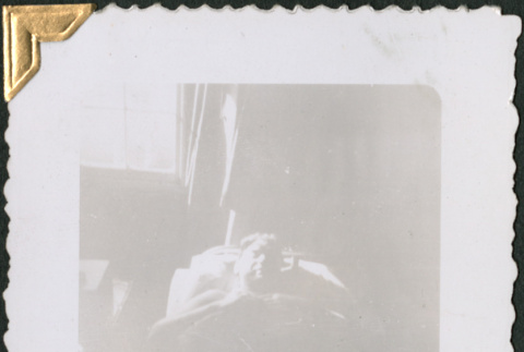 Man laying on cot (ddr-densho-434-67)