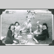 Three women and two men in uniform having a picnic (ddr-ajah-2-523)
