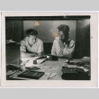 Two men at a desk (ddr-densho-377-1649)