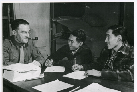 Two young Nisei men signing enlistment papers (ddr-densho-122-760)