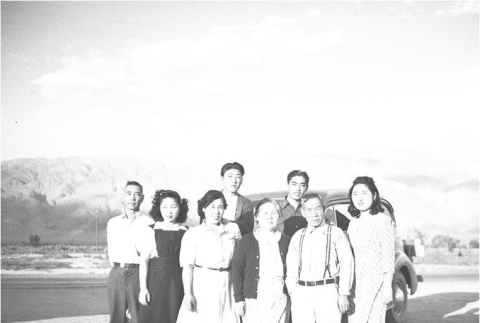 Group of Japanese Americans in front of a car (ddr-densho-153-294)