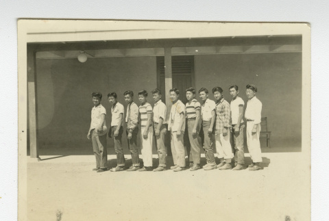 Nisei men's basketball team standing in front of barrack (ddr-csujad-44-21)