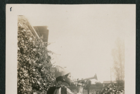 Boy in costume playing trumpet (behind) (ddr-densho-378-450)