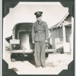 Man in uniform standing next to car (ddr-ajah-2-75)