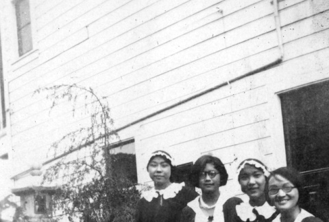 Four women standing outside house (ddr-ajah-6-275)