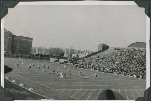 Football game in stadium with crowd in bleachers (ddr-ajah-2-514)