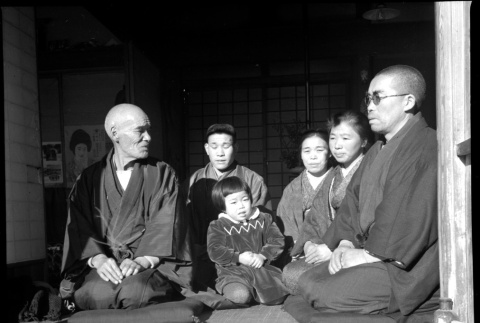 Family seated in doorway of house (ddr-densho-426-311)