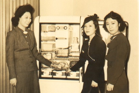 Fumiko Kawabata and two young women posing with a refrigerator (ddr-njpa-4-592)