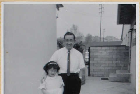 Man with girl in patio of house (ddr-densho-522-63)