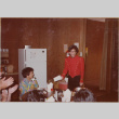 Group sitting at table, man dressed as telegram messenger (ddr-densho-426-1327)